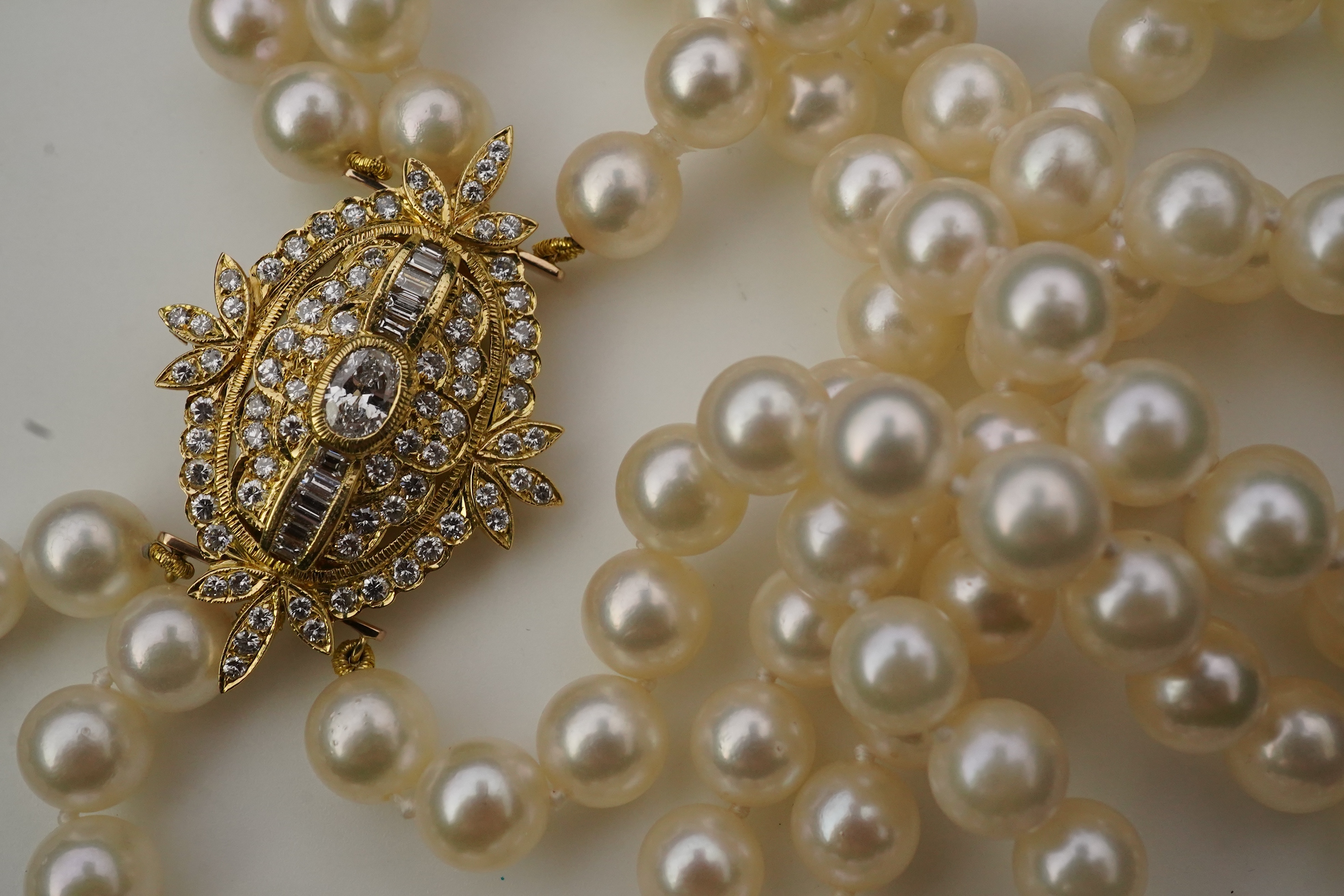 A cultured pearl and diamond necklace/brooch